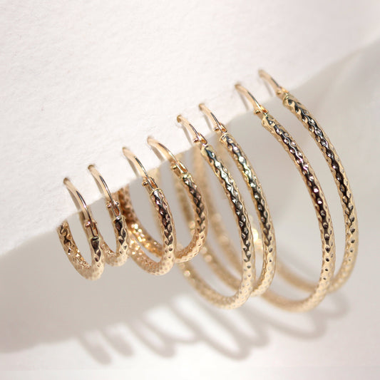 Boucles d'oreilles créoles torsadées en or jaune 9 carats